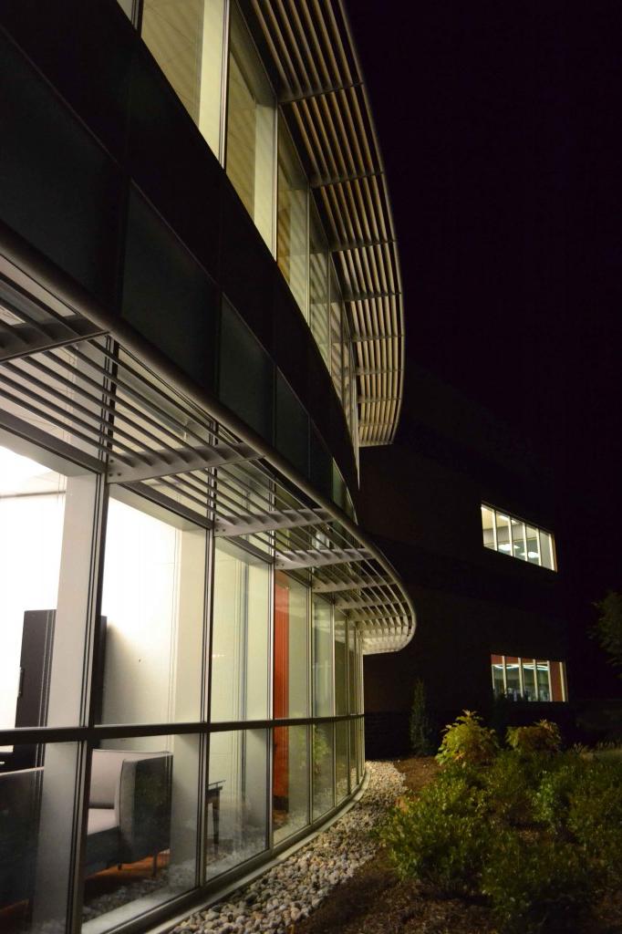 A photo taken of a building outside at night
