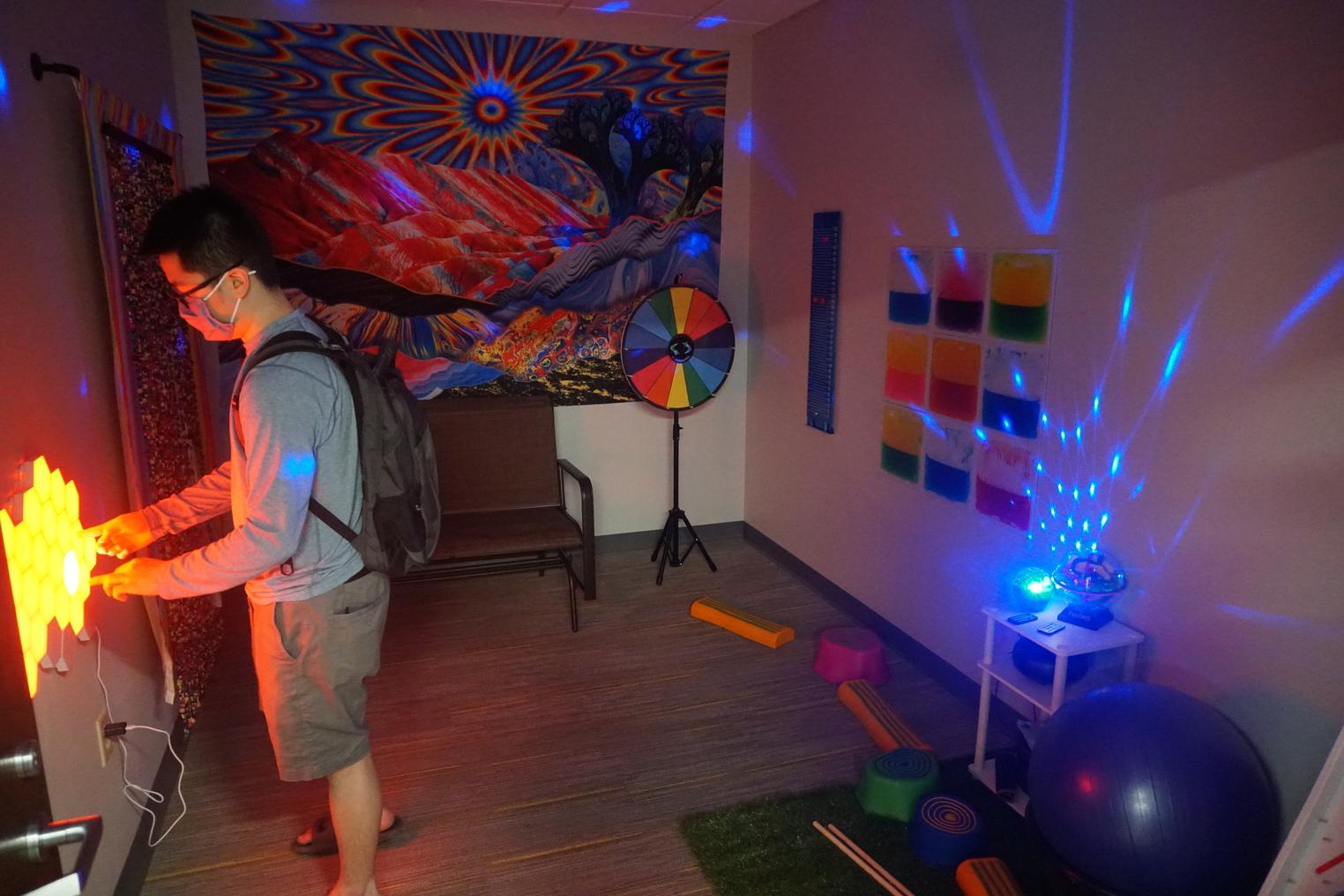 A student in a room with many flashing lights