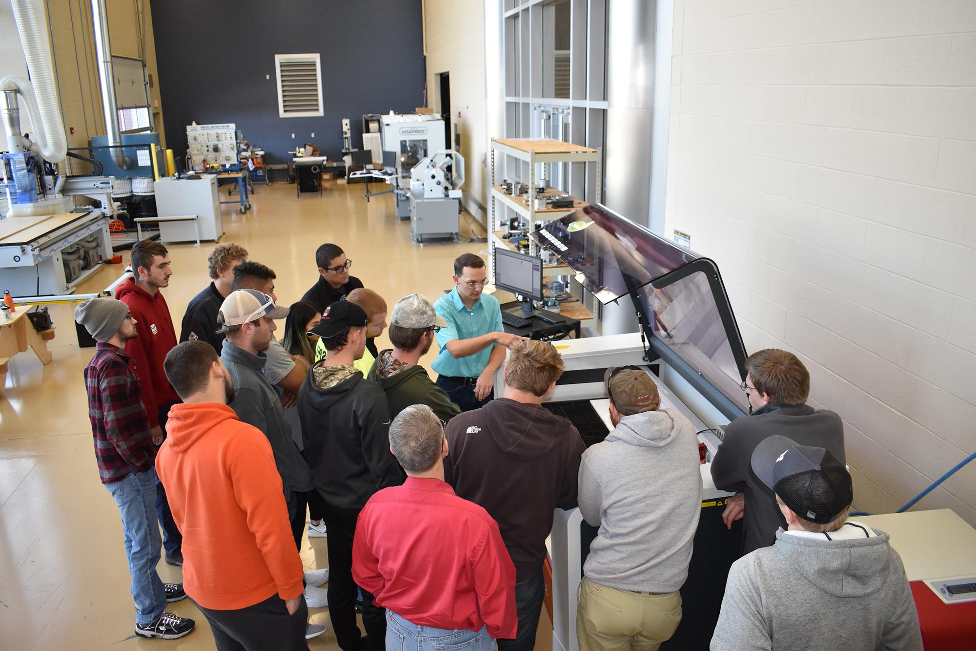 A Jasper professor giving a tour of the Technology Center to some students