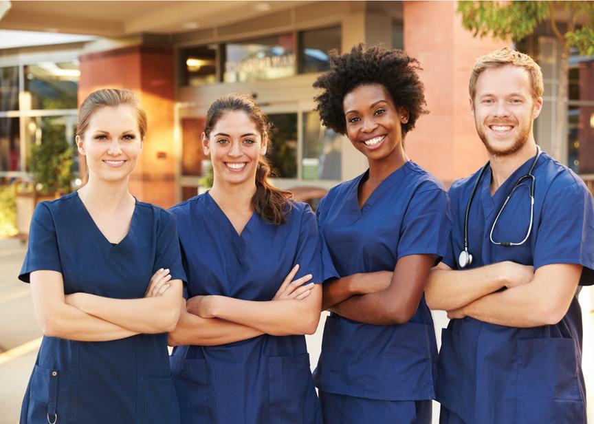 Nurses standing side by side in front of a clinic