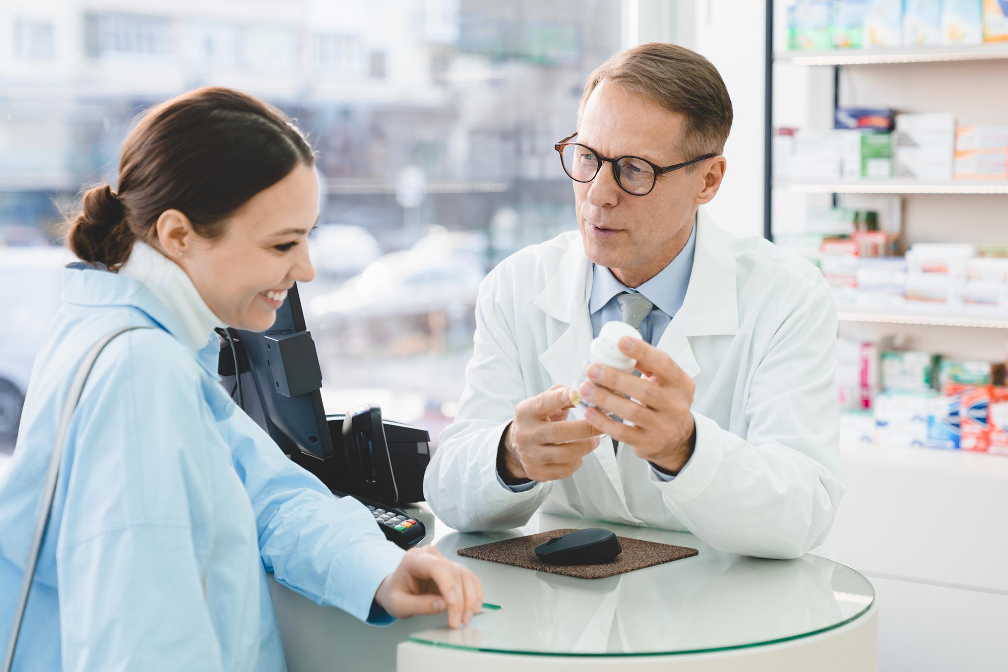 A pharmacist talking to a customer about their medication