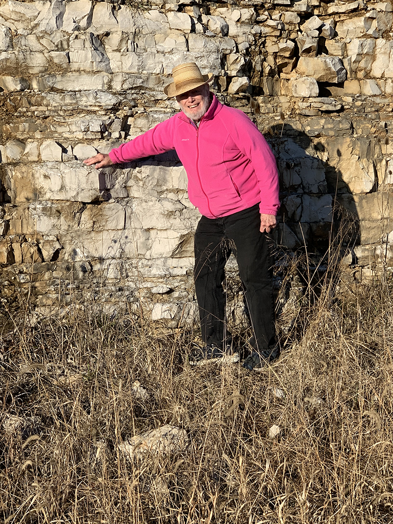 Robert Metz standing against a brick wall