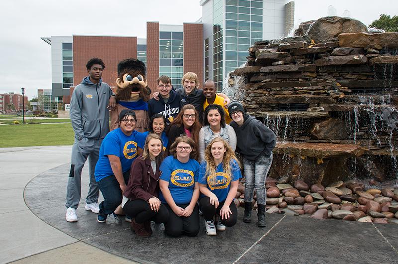 A group of students posing with the mascot for Vincennes University next to Updike Fountain